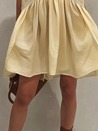 Yellow Sleeveless Mini Dress with Deep V-Neck and Lace Trim